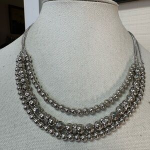 Triple strand silvertone necklace with rhinestone spacer beads